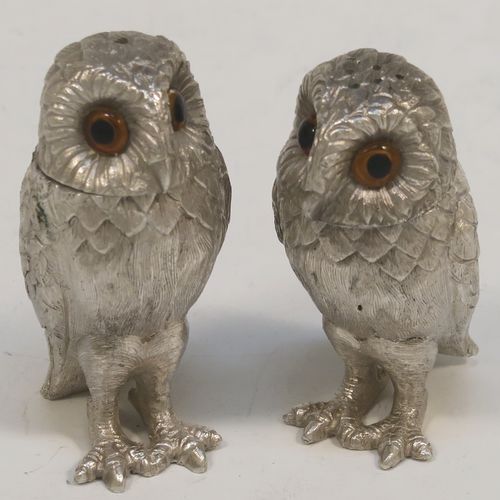 A very pretty pair of cast Sterling Silver Owl salt and pepper shaker pots, having hand-chased barn owl bodies with amber glass eyes and pull-off pierced heads. This beautiful pair of cast sterling silver owl salt and pepper shakers were made by Robert Comyns of London in 1992. The dimensions of this fine hand-made silver pair of owl condiments are height 6 cms (2.3 inches), width 3 cms (1.25 inches), and they weigh a total of approx. 126g (4 troy ounces).   