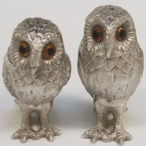 A very pretty pair of cast Sterling Silver Owl salt and pepper shaker pots, having hand-chased barn owl bodies with amber glass eyes and pull-off pierced heads. This beautiful pair of cast sterling silver owl salt and pepper shakers were made by Robert Comyns of London in 1992. The dimensions of this fine hand-made silver pair of owl condiments are height 6 cms (2.3 inches), width 3 cms (1.25 inches), and they weigh a total of approx. 126g (4 troy ounces).   