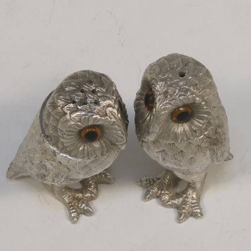 A very pretty pair of cast Sterling Silver Owl salt and pepper shaker pots, having hand-chased barn owl bodies with amber glass eyes and pull-off pierced heads. This beautiful pair of cast sterling silver owl salt and pepper shakers were made by Robert Comyns of London in 1992. The dimensions of this fine hand-made silver pair of owl condiments are height 6 cms (2.3 inches), width 3 cms (1.25 inches), and they weigh a total of approx. 126g (4 troy ounces).   