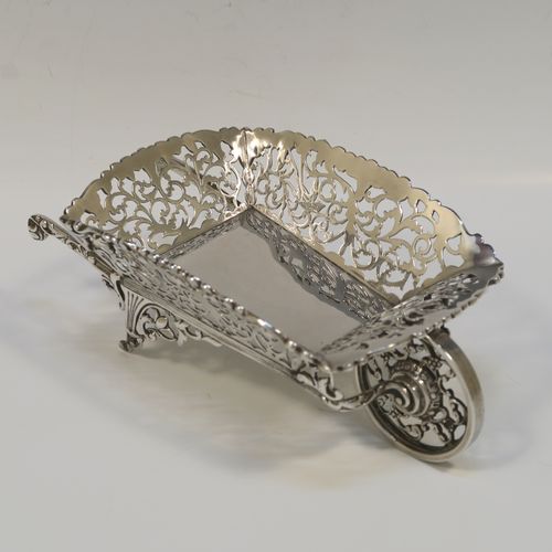 A rare and beautiful Antique Edwardian Sterling Silver pot-pouri holder in the shape of a garden wheelbarrow, having a hand-pierced body with scroll and bird decoration, an applied and cast floral top border, a rotating front wheel, and sitting on a frame with two cast rear handles and hand-pierced feet. This very pretty silver wheelbarrow style pot pourri holder was made by Nathan and Hayes of Chester in 1908. The dimensions of this fine hand-made antique silver garden wheelbarrow are length height 5 cms (2 inches), length 18.5 cms (7.25 inches), width 10 cms (4 inches), and it weighs approx. 224g (7.2 troy ounce).  