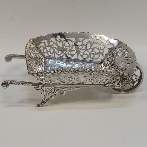 A rare and beautiful Antique Edwardian Sterling Silver pot-pouri holder in the shape of a garden wheelbarrow, having a hand-pierced body with scroll and bird decoration, an applied and cast floral top border, a rotating front wheel, and sitting on a frame with two cast rear handles and hand-pierced feet. This very pretty silver wheelbarrow style pot pourri holder was made by Nathan and Hayes of Chester in 1908. The dimensions of this fine hand-made antique silver garden wheelbarrow are length height 5 cms (2 inches), length 18.5 cms (7.25 inches), width 10 cms (4 inches), and it weighs approx. 224g (7.2 troy ounce).  