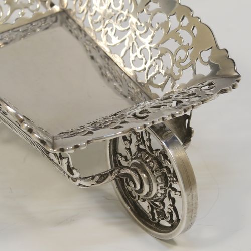 A rare and beautiful Antique Edwardian Sterling Silver pot-pouri holder in the shape of a garden wheelbarrow, having a hand-pierced body with scroll and bird decoration, an applied and cast floral top border, a rotating front wheel, and sitting on a frame with two cast rear handles and hand-pierced feet. This very pretty silver wheelbarrow style pot pourri holder was made by Nathan and Hayes of Chester in 1908. The dimensions of this fine hand-made antique silver garden wheelbarrow are length height 5 cms (2 inches), length 18.5 cms (7.25 inches), width 10 cms (4 inches), and it weighs approx. 224g (7.2 troy ounce).  