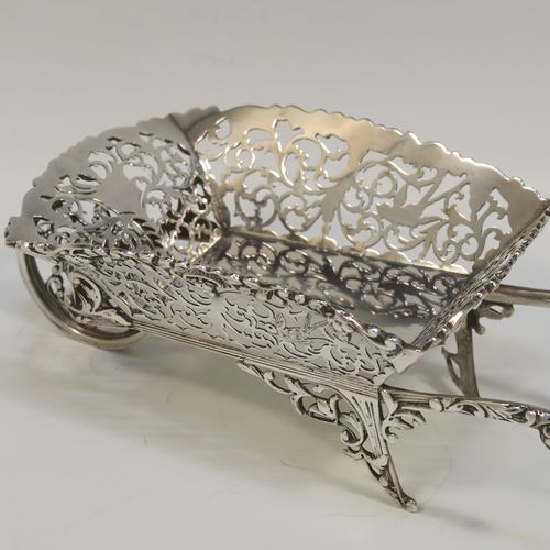 A rare and beautiful Antique Edwardian Sterling Silver pot-pouri holder in the shape of a garden wheelbarrow, having a hand-pierced body with scroll and bird decoration, an applied and cast floral top border, a rotating front wheel, and sitting on a frame with two cast rear handles and hand-pierced feet. This very pretty silver wheelbarrow style pot pourri holder was made by Nathan and Hayes of Chester in 1908. The dimensions of this fine hand-made antique silver garden wheelbarrow are length height 5 cms (2 inches), length 18.5 cms (7.25 inches), width 10 cms (4 inches), and it weighs approx. 224g (7.2 troy ounce).  