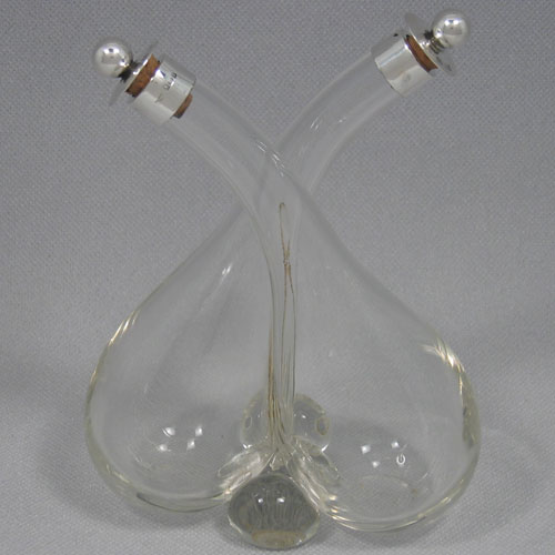    Edwardian sterling silver oil & vinegar 'tipper' set made by Heath & Middleton of Birmingham in 1909. Height 17 cms, width 13 cms.