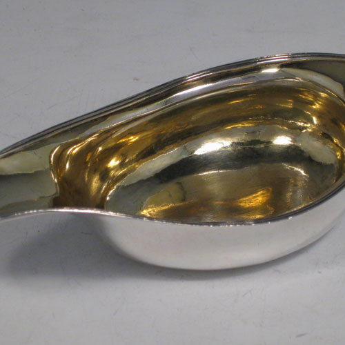 Antique Georgian sterling silver pap boat, having an applied reeded border, and gold-gilt interior. Made in London in 1794. Length 13 cms (5 inches), width 7 cms (2.75 inches). Weight approx. 60g (2 troy ounces).