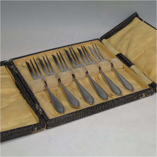 A Sterling Set of six pastry forks, having single-struck bead and pearl handles, and three tined forks, all in their original satin and velvet-lined presentation box. Made by Suckling Ltd., of Birmingham in 1925. The dimensions of these fine hand-made silver pastry forks are length 12.5 cms (5 inches), and they weigh a total of 99g (3.2 troy ounces). Please note that the interior satin lining is damaged and the exterior of the box has worn corners.