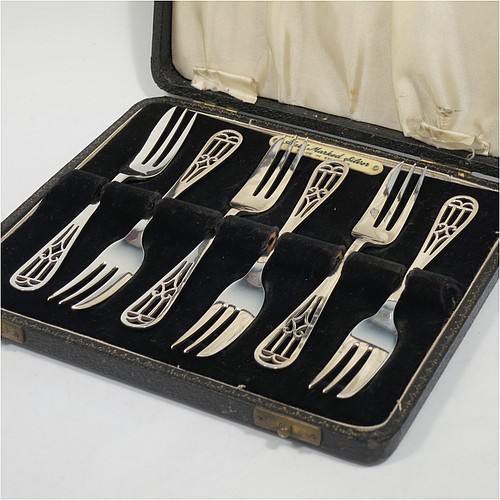 A very pretty and unusual Sterling Silver set of six pastry forks, having hand-pierced handles, and three tined forks, all in their original cream satin and black velvet-lined presentation box. Made by Angora Silver Co., of Birmingham in 1949. The dimensions of these fine hand-made silver pastry forks are length 13.5 cms (5.25 inches), and they weigh a total of 104g (3.4 troy ounces). Please note that the interior satin straps that cover the hinges are damaged.   