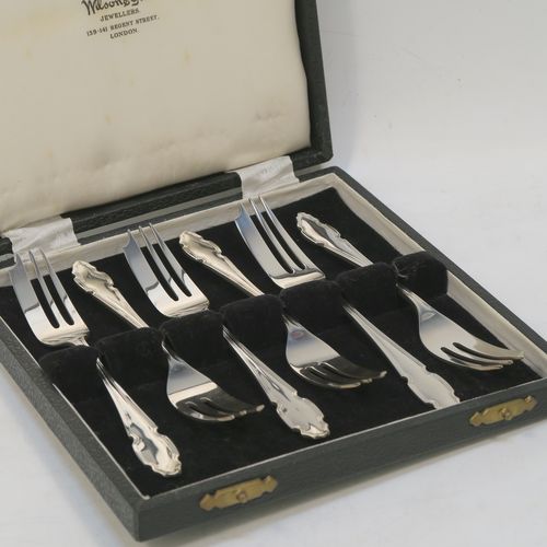 A very handsome Sterling Silver set of six pastry forks, having Chippendale or Dubarry pattern handles, and three tined forks, all in their original cream satin and black velvet-lined presentation box. Made by the Cooper Brothers of Sheffield in 1935. The dimensions of these fine hand-made silver pastry forks are length 13 cms (5.25 inches), and they weigh a total of 132g (4.3 troy ounces). Please note that the box is in good overall condition, and the lid closes properly, but the whole box is slightly warped. 