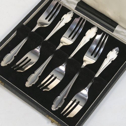 A very handsome Sterling Silver set of six pastry forks, having Chippendale or Dubarry pattern handles, and three tined forks, all in their original cream satin and black velvet-lined presentation box. Made by the Cooper Brothers of Sheffield in 1935. The dimensions of these fine hand-made silver pastry forks are length 13 cms (5.25 inches), and they weigh a total of 132g (4.3 troy ounces). Please note that the box is in good overall condition, and the lid closes properly, but the whole box is slightly warped. 