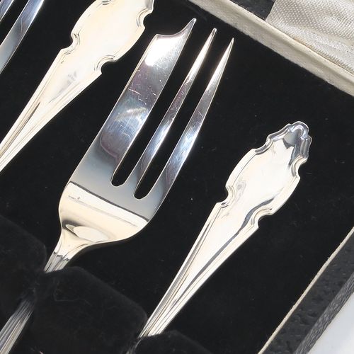 A very handsome Sterling Silver set of six pastry forks, having Chippendale or Dubarry pattern handles, and three tined forks, all in their original cream satin and black velvet-lined presentation box. Made by the Cooper Brothers of Sheffield in 1935. The dimensions of these fine hand-made silver pastry forks are length 13 cms (5.25 inches), and they weigh a total of 132g (4.3 troy ounces). Please note that the box is in good overall condition, and the lid closes properly, but the whole box is slightly warped. 