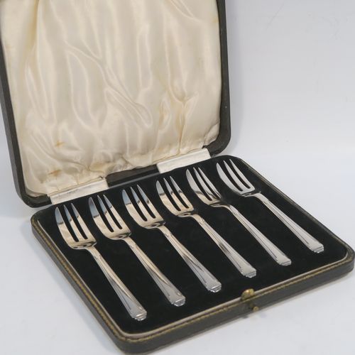 A very elegant Sterling Silver set of six pastry forks in an Art Deco style pattern, with three tined forks, all in their original cream satin and black velvet-lined presentation box. These handsome silver pastry forks were made by the Barker Brothers of Birmingham in 1935. The dimensions of this fine set of hand-made silver pastry forks are length 13 cms (5 inches), and they weigh a total of 136g (4.4 troy ounces).    