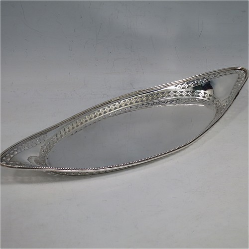 A very pretty Antique Victorian Sterling Silver pen tray, having an oval body, an applied bead border with bands of hand-engraved and hand-pierced geometrical decoration, and sitting on a flat base. Made by Charles Stuart Harris of London in 1899. The dimensions of this fine hand-made antique silver pen tray are length 27 cms (10.5 inches), width 10 cms (4 inches), and it weighs approx. 137g (4.4 troy ounces).    