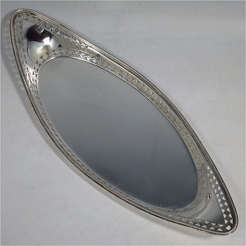 A very pretty Antique Victorian Sterling Silver pen tray, having an oval body, an applied bead border with bands of hand-engraved and hand-pierced geometrical decoration, and sitting on a flat base. Made by Charles Stuart Harris of London in 1899. The dimensions of this fine hand-made antique silver pen tray are length 27 cms (10.5 inches), width 10 cms (4 inches), and it weighs approx. 137g (4.4 troy ounces).    