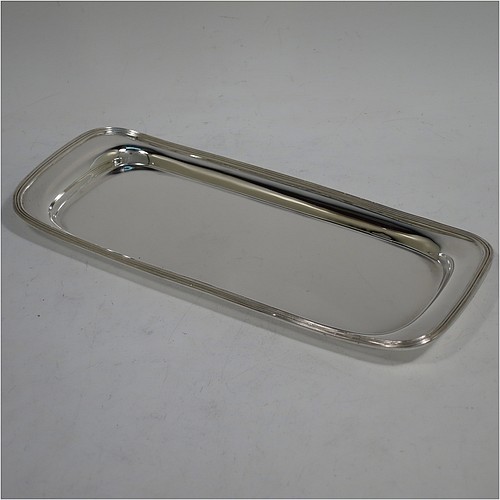 A very handsome Antique Victorian Sterling Silver pen tray, having a rectangular body with raised edge and rounded corners, an applied reeded border, and a plain ground, sitting on a flat base. Made by Charles Stuart Harris of London in 1895. The dimensions of this fine hand-made antique silver pen tray are length 21.5 cms (8.5 inches), width 9.5 cms (3.75 inches), and it weighs approx. 150g (4.8 troy ounces).    