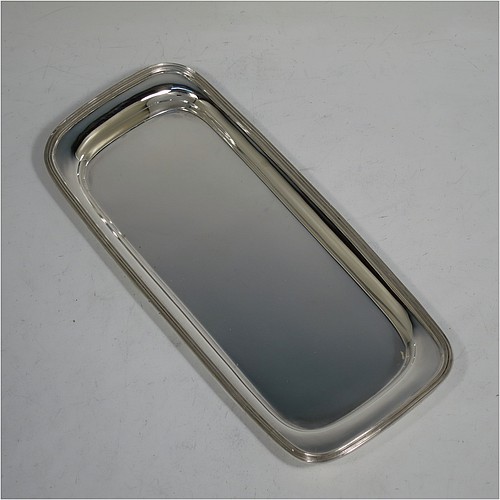 A very handsome Antique Victorian Sterling Silver pen tray, having a rectangular body with raised edge and rounded corners, an applied reeded border, and a plain ground, sitting on a flat base. Made by Charles Stuart Harris of London in 1895. The dimensions of this fine hand-made antique silver pen tray are length 21.5 cms (8.5 inches), width 9.5 cms (3.75 inches), and it weighs approx. 150g (4.8 troy ounces).    