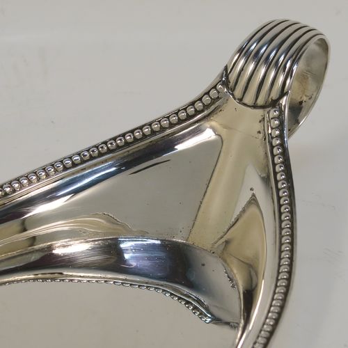 A very handsome Antique Georgian Sterling Silver pen tray, having a very plain oval body with applied beaded borders, with looped and reeded side-handles, and all sitting on a flat base. This elegant antique silver pen tray was made by John Schofield of Lndon in 1779. The dimensions of this fine hand-made antique silver pen tray are length 25.5 cms (10 inches), width 9.5 cms (3.75 inches), and it weighs approx. 138g (4.5 troy ounces).   