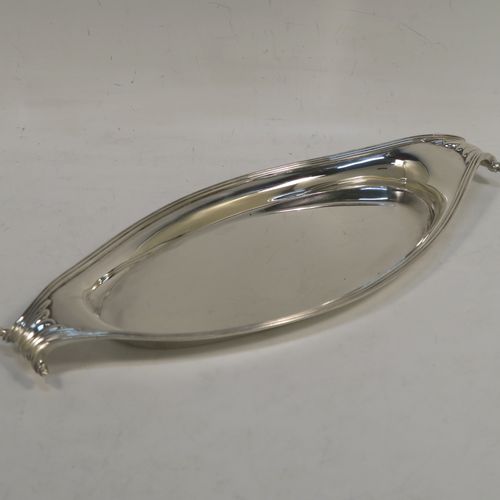 A very elegant Antique Victorian Sterling Silver pen tray, having a very plain oval body with applied reeded borders, cast scrolled handles at either end, and all sitting on a flat base. This beautiful antique silver pen tray was made by D. and J. Welby of London in 1893. The dimensions of this fine hand-made antique silver pen tray are length 23 cms (9 inches), width 10 cms (4 inches), and it weighs approx. 152g (4.9 troy ounces).   