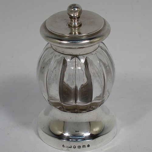 A handsome Antique Victorian Sterling Silver and hand-cut crystal pepper grinder, having a round crystal body with a hand-cut melon fluted pattern, plain round mounts top and bottom with knurled ball finial, and an original Peugeot grinding mechanism. Made by John Greene and Co., of Birmingham in 1888. The dimensions of this fine hand-made antique silver and crystal pepper grinder are height 9.5 cms (3.75 inches), and diameter at base 5.5 cms (2.25 inches).    