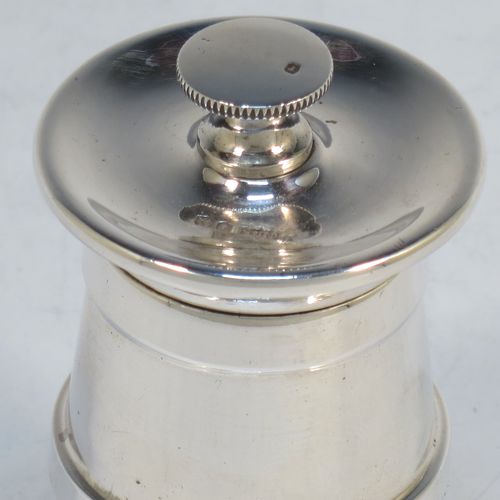 A handsome Sterling Silver pepper grinder in a milk churn style, having a plain tapering straight sided body with three applied bands of decoration, with a knurled grinder finial, and a steel grinder mechanism. Made by James Dixon of Sheffield in 1966. The dimensions of this fine hand-made silver pepper grinder are height 7.5 cms (3 inches), and diameter at base 5 cms (2 inches).   