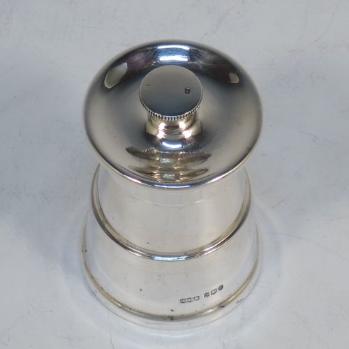 A handsome Sterling Silver pepper grinder in a milk churn style, having a plain tapering straight sided body with three applied bands of decoration, with a knurled grinder finial, and a steel grinder mechanism. Made by James Dixon of Sheffield in 1966. The dimensions of this fine hand-made silver pepper grinder are height 7.5 cms (3 inches), and diameter at base 5 cms (2 inches).   