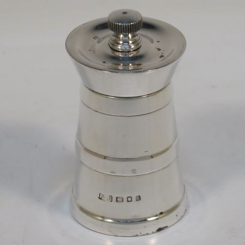 A very handsome Sterling Silver pepper grinder in a milk churn style, having a plain tapering straight sided body with three applied bands of decoration, with a knurled grinder finial, and a Peter Piper grinder mechanism. This elegant silver pepper grinder was made by Park Green and Co., of London in 1957. The dimensions of this fine hand-made silver pepper grinder are height 7.5 cms (3 inches), and diameter at base 4 cms (1.5 inches).   