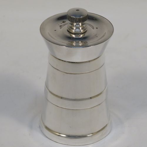 A very handsome Sterling Silver pepper grinder in a milk churn style, having a plain tapering straight sided body with three applied bands of decoration, with a knurled grinder finial, and a Peter Piper grinder mechanism. This elegant silver pepper grinder was made by Park Green and Co., of London in 1957. The dimensions of this fine hand-made silver pepper grinder are height 7.5 cms (3 inches), and diameter at base 4 cms (1.5 inches).   