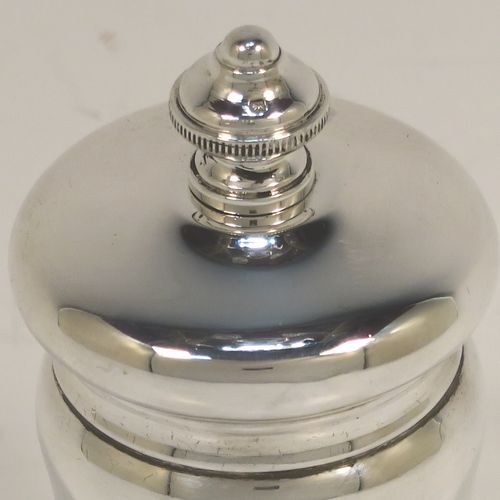 A handsome Antique Sterling Silver pepper grinder, having a plain round bellied body, an original Peugeot grinder mechanism, and a knurled round urn-shaped finial. This beautiful silver pepper grinder was made by S. W. Smith and Co., of Birmingham in 1924. The dimensions of this fine hand-made antique silver pepper grinder are height 10 cms (4 inches), diameter 5 cms (2 inches), and it weighs approx. 125g (4 troy ounces).   