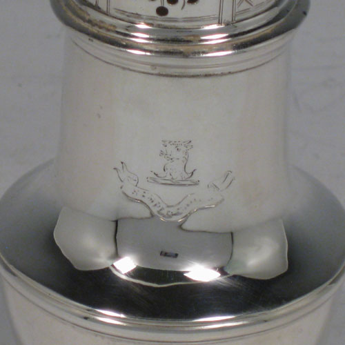 Antique Georgian sterling silver pepper pot, having a plain baluster body, a hand-pierced pull-off lid with urn-shaped finial, and sitting on a pedestal foot. Made by Samuel Woods of London in 1747. The dimensions of this fine hand-made silver pepper pot are height 15 cms (6 inches), diameter of main body 6 cms (2.3 inches), and it weighs approx. 148g (4.8 troy ounces). Please note that this item is crested.   