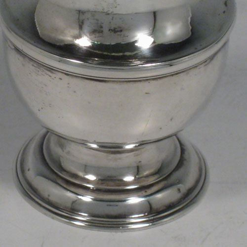 Antique Georgian sterling silver pepper pot, having a plain baluster body, a hand-pierced pull-off lid with finial, and sitting on a pedestal foot. Made by Thomas Bamford I of London in 1736. The dimensions of this fine hand-made silver pepper pot are height 13.5 cms (5.3 inches), diameter of main body 4.5 cms (1.75 inches), and it weighs approx. 101g (3.3 troy ounces).   