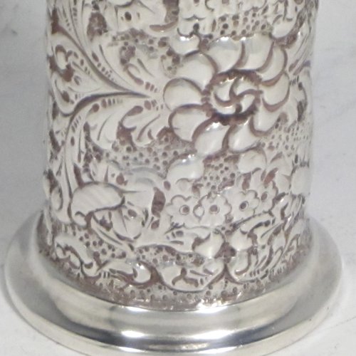 Antique Victorian sterling silver pepper pot (or small sugar caster), having a cylindrical body with hand-chased floral decoration, a hand-pierced pull-off lid, and sitting on a collet foot. Made by Nathan & Hayes of Chester in 1895. The dimensions of this fine hand-made silver caster / pepper pot are height 10 cms (4 inches), diameter at base main body 4 cms (1.5 inches), and it weighs approx. 85g (2.7 troy ounces)    