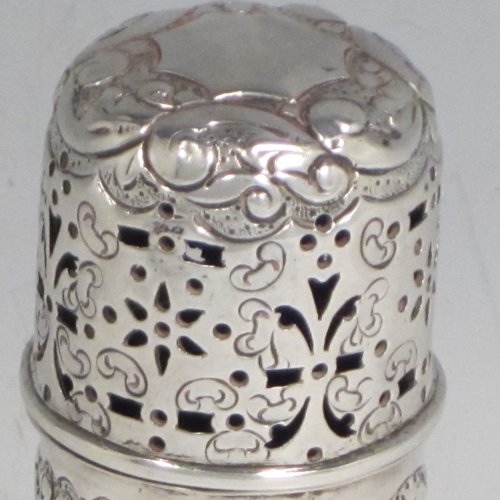 Antique Victorian sterling silver pepper pot (or small sugar caster), having a cylindrical body with hand-chased floral decoration, a hand-pierced pull-off lid, and sitting on a collet foot. Made by Nathan & Hayes of Chester in 1895. The dimensions of this fine hand-made silver caster / pepper pot are height 10 cms (4 inches), diameter at base main body 4 cms (1.5 inches), and it weighs approx. 85g (2.7 troy ounces)    