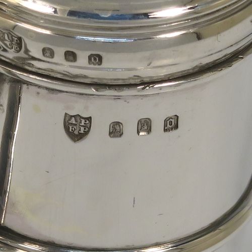 A very handsome Silver Kitchen pepper made in the Britannia Standard, having a plain round straight-sided body with an applied central girdle, a pull-off hand-pierced lid, a cast scroll side-handle, and siting on a stepped collet foot. This Britannia Standard silver kitchen pepper pot was made by the Pairpoint Brothers of London in 1929. The dimension of this silver kitchen pepper are height 7.5 cms (3 inches), length 7 cms (2.75 inches), and it weighs approx. 149g (4.8 troy ounce).   