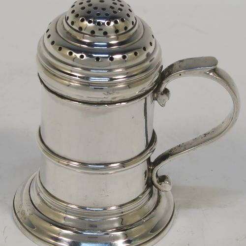 A very handsome Silver Kitchen pepper made in the Britannia Standard, having a plain round straight-sided body with an applied central girdle, a pull-off hand-pierced lid, a cast scroll side-handle, and siting on a stepped collet foot. This Britannia Standard silver kitchen pepper pot was made by the Pairpoint Brothers of London in 1929. The dimension of this silver kitchen pepper are height 7.5 cms (3 inches), length 7 cms (2.75 inches), and it weighs approx. 149g (4.8 troy ounce).   