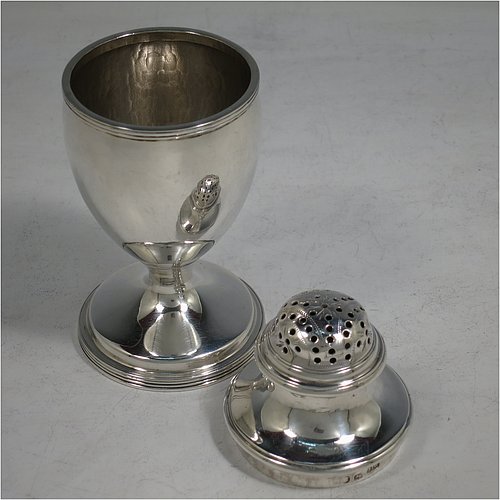 An Antique Georgian George III Sterling Silver bun style pepper pot, having a plain round body with applied reeded borders, a hand-pierced pull-off domed lid, and sitting on a pedestal foot. Made by Henry Green of London in 1794. The dimensions of this fine hand-made antique silver pepper pot are height 13 cms (5 inches), diameter of main body 5 cms (2 inches), and it weighs approx. 164g (5.3 troy ounces).    