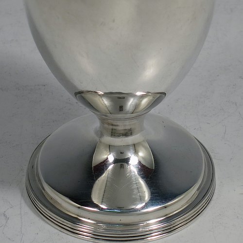 An Antique Georgian George III Sterling Silver bun style pepper pot, having a plain round body with applied reeded borders, a hand-pierced pull-off domed lid, and sitting on a pedestal foot. Made by Henry Green of London in 1794. The dimensions of this fine hand-made antique silver pepper pot are height 13 cms (5 inches), diameter of main body 5 cms (2 inches), and it weighs approx. 164g (5.3 troy ounces).    