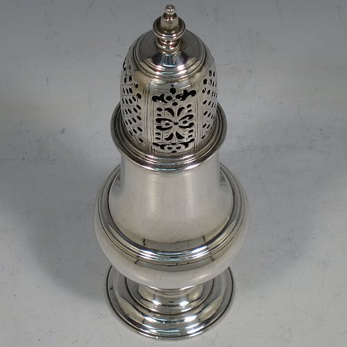 An Antique Georgian George II Sterling Silver pepper pot, having a plain baluster body with applied reeded borders, a hand-pierced pull-off lid with urn-shaped finial, and sitting on a pedestal foot. Made by Samuel Woods of London in 1758. The dimensions of this fine hand-made antique silver pepper pot are height 15 cms (6 inches), diameter of main body 5 cms (2 inches), and it weighs approx. 131g (4.2 troy ounces).   