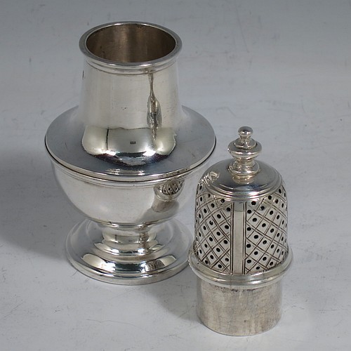 An Antique Victorian Sterling Silver pepper shaker or pot in a George II style, having a plain round bellied body, with reeded borders, pull-off hand-pierced lid with a cast finial, and sitting on a pedestal foot. Made by Nathan & Hayes of Chester in 1897. The dimensions of this fine hand-made antique silver pepper pot or shaker are height 11 cms (4.3 inches), diameter 5 cms (2 inches), and it weighs approx. 85g (2.7 troy ounces).