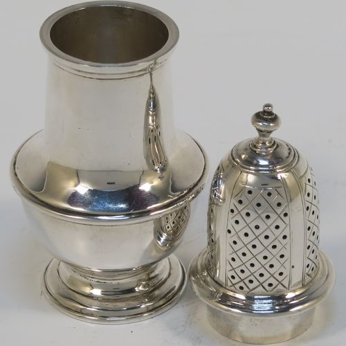 A very handsome Antique Sterling Silver pepper pot, in a Georgian style, having a plain round bellied body with applied reeded borders, a hand-pierced pull-off lid with urn-shaped finial, and sitting on a pedestal foot. This elegant silver pepper pot was made by Goldsmiths and Silversmiths of London in 1920. The dimensions of this fine hand-made antique silver pepper pot are height 11 cms (4.3 inches), diameter of main body 4.5 cms (1.75 inches), and it weighs approx. 105g (3.4 troy ounces).   