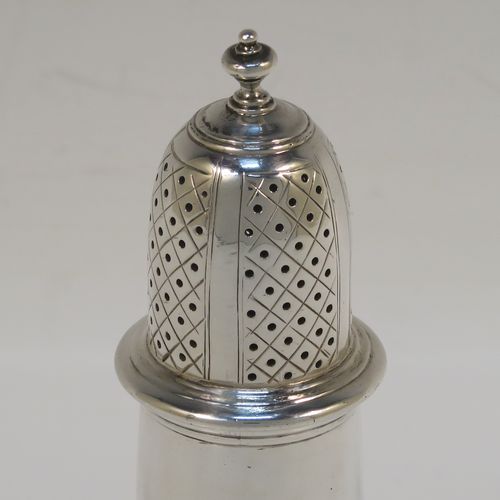 A very handsome Antique Sterling Silver pepper pot, in a Georgian style, having a plain round bellied body with applied reeded borders, a hand-pierced pull-off lid with urn-shaped finial, and sitting on a pedestal foot. This elegant silver pepper pot was made by Goldsmiths and Silversmiths of London in 1920. The dimensions of this fine hand-made antique silver pepper pot are height 11 cms (4.3 inches), diameter of main body 4.5 cms (1.75 inches), and it weighs approx. 105g (3.4 troy ounces).   