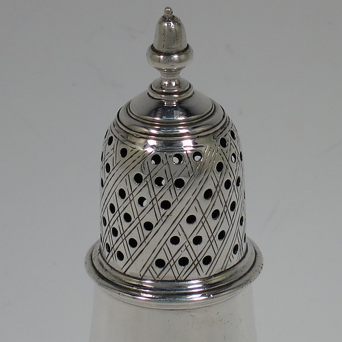 A very handsome Antique Georgian George III Sterling Silver pepper pot, having a plain baluster body with applied reeded borders, a hand-pierced pull-off lid with acorn finial, and sitting on a pedestal foot. Made by John Denziloe of London in 1779. The dimensions of this fine hand-made antique silver pepper pot are height 14 cms (5.5 inches), diameter of main body 5 cms (2 inches), and it weighs approx. 83g (2.7 troy ounces).   