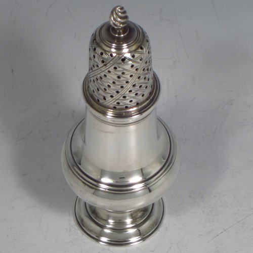 An Antique Georgian sterling silver pepper pot, having a plain round baluster body, a hand-pierced pull-off lid with flame finial, and sitting on a pedestal foot. Made by James Delmester of London in 1766. The dimensions of this fine hand-made antique silver pepper pot are height 12 cms (4.75 inches), diameter of main body 4.5 cms (1.75 inches), and it weighs approx. 63g (2 troy ounces).