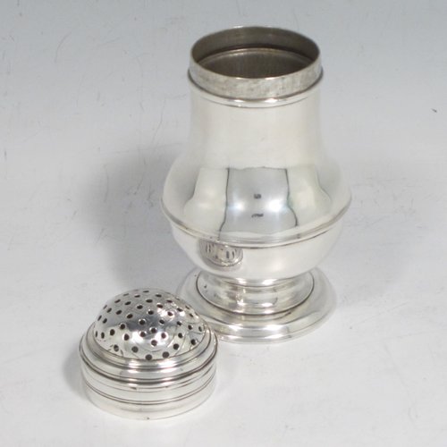 Antique Georgian sterling silver Bun style pepper pot, having a plain round baluster body, with applied and hand-engraved reeded decoration, a pull-off pierced lid, and sitting on a pedestal foot. Made in London in 1749. The dimensions of this fine hand-made silver pepper pot are height 9 cms (3.5 inches), diameter 4.5 cms (1.75 inches), and it weighs approx. 66g (2 troy ounces).   