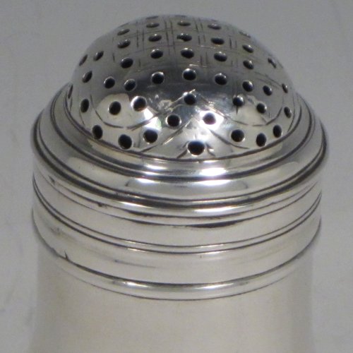 Antique Georgian sterling silver Bun style pepper pot, having a plain round baluster body, with applied and hand-engraved reeded decoration, a pull-off pierced lid, and sitting on a pedestal foot. Made in London in 1749. The dimensions of this fine hand-made silver pepper pot are height 9 cms (3.5 inches), diameter 4.5 cms (1.75 inches), and it weighs approx. 66g (2 troy ounces).   