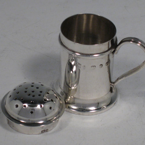 Antique Victorian sterling silver Kitchen pepperette, having a round straight-sided body, pull-off hand-pierced lid, and a scroll handle. Made by Nathan and Hayes of Birmingham in 1892. Height 5 cms (2 inches), length 5 cms (2 inches). Weight approx. 31g (1 troy ounce).