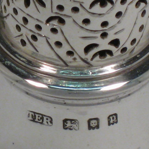    Sterling silver pair of pepper pots, in a George I style, having round plain bellied bodies with a central reeded band, pull-off hand-pierced lids with cast knop finials, and sitting on pedestal feet. Made in London in 1930/31. Height 11 cms (4.25 inches), diameter of bodies 4 cms (1.5 inches). Total weight 177g (5.7 troy ounces).