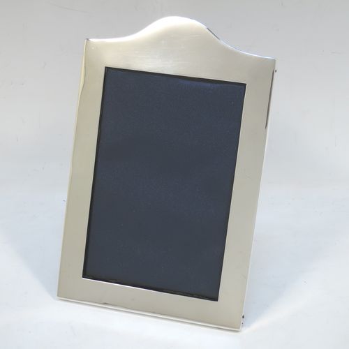 A very handsome Antique Sterling Silver portrait photograph frame, having a hand-made very plain rectangular body with pinned edges and domed upper border, and a dark blue velvet-backed easel frame. Made by William Comyns of London in 1911. The internal dimensions of this fine hand-made antique silver photo frame are height 13 cms (5 inches), and width 9 cms (3.5 inches).   