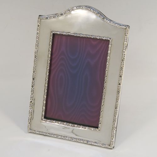 A very pretty Antique Sterling Silver portrait photograph frame, having a hand-made rectangular body with pinned edges, a double pearl and dart border, and an original wood-backed easel frame. This beautiful antique silver photo frame was made by James and Walter Deakin of Sheffield 1918. The internal dimensions of this fine hand-made antique silver photo frame are height 13 cms (5 inches), and width 8.5 cms (3.3 inches).   