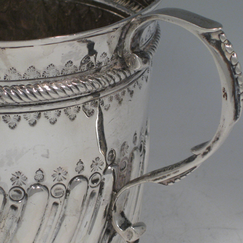 Antique Georgian sterling silver two-handled loving cup poringer with hand-chased and fluted decoration, made in London in 1756. Height 13 cms (5.25 inches), width across handles 20 cms (8inches). Weight approx. 12 troy ounces (372g).