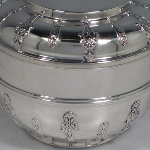 Antique Victorian sterling silver porringer and lid, having a round baluster body, a round lift-off lid, two oxe-eye side handles, all decorated with applied strap-work motifs, and sittng on a collet foot. Made by Holland, Aldwinckle, and Slater of London 1897. The dimensions of this fine hand-made silver porringer and lid are height 9 cms (3.5 inches), spread across arms 16. cms (6.5 inches), and it weighs approx. 324g (10.5 troy ounces).