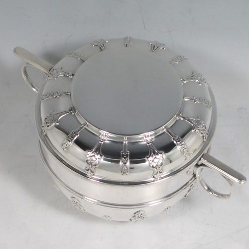 Antique Victorian sterling silver porringer and lid, having a round baluster body, a round lift-off lid, two oxe-eye side handles, all decorated with applied strap-work motifs, and sittng on a collet foot. Made by Holland, Aldwinckle, and Slater of London 1897. The dimensions of this fine hand-made silver porringer and lid are height 9 cms (3.5 inches), spread across arms 16. cms (6.5 inches), and it weighs approx. 324g (10.5 troy ounces).